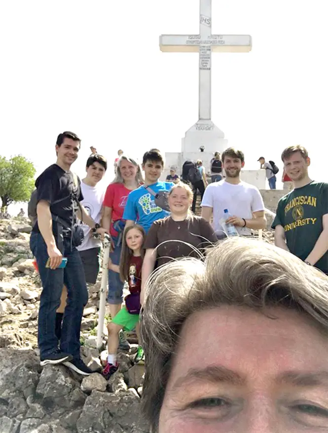 This is a photo of the Richard L George Family picture with the Cross in the background